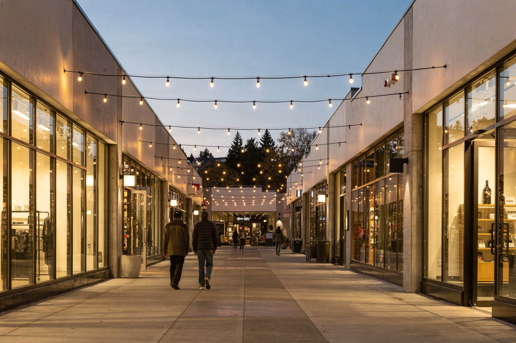 evening view of a Coquitlam outdoor shopping walkway strung with string lights