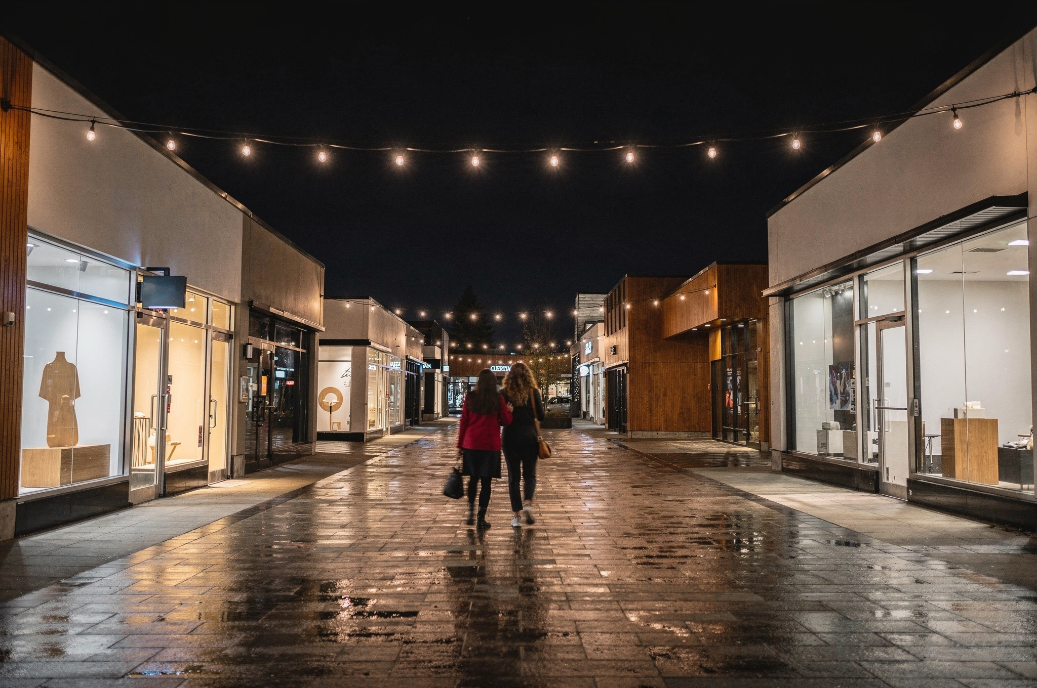 nighttime view of a Coquitlam pedestrian shopping lane strung with string lights