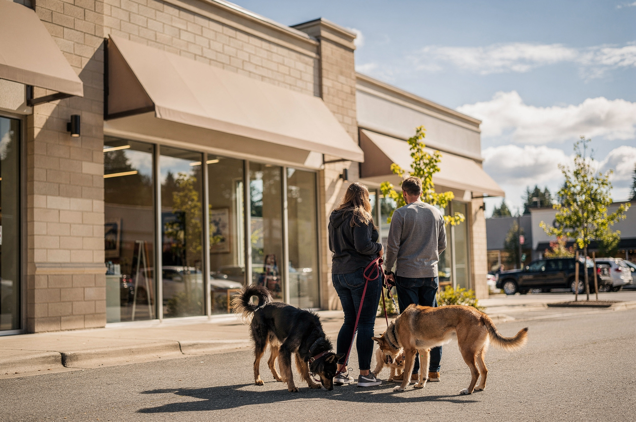 pet store visitors with dogs in front